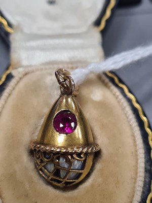 Lot 280 - A LATE 19TH CENTURY FABERGE 14CT GOLD ENAMEL AND RUBY PENDANT EGG, WORKMASTER HENRIK WIGSTROM