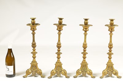 Lot 501 - A SET OF FOUR 18TH CENTURY CONTINENTAL LARGE BRASS CANDLESTICKS