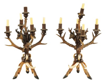 Lot 743 - AN UNUSUAL PAIR OF 19TH CENTURY BLACK FOREST POLYCHROME CARVED WOOD, ANTLER HORN AND BOAR’S TUSK FIVE BRANCH CANDELABRA