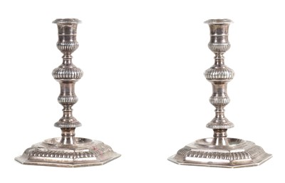 Lot 254 - A PAIR OF ELIZABETH II CAST SILVER CANDLESTICKS