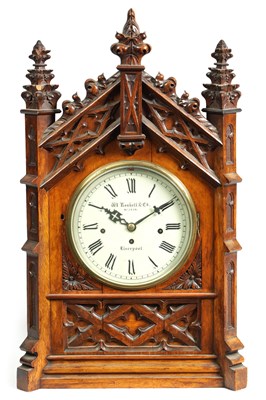 Lot 441 - W. ROSKELL, & CO. LIVERPOOL. A LATE 19TH CENTURY GOTHIC OAK TRIPLE FUSEE BRACKET CLOCK