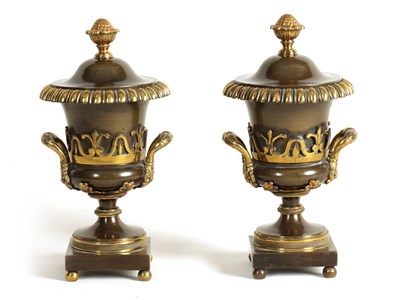 Lot 543 - A PAIR OF REGENCY BRONZE AND GILT BRONZE URN SHAPED CASSOLETES/CANDLESTICKS