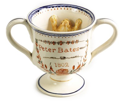 Lot 65 - AN EARLY 19TH CENTURY CREAMWARE LOVING CUP inscribed PETER BATES 1802