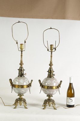 Lot 718 - A PAIR OF LATE 19TH CENTURY CAST GILT BRASS AND PORCELAIN OIL LAMPS CONVERTED FOR ELECTRICITY