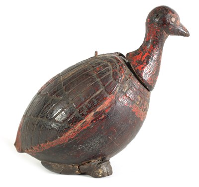 Lot 311 - AN UNUSUAL CARVED COCONUT LIDDED POLYCHROME DECORATED CANISTER FORMED AS A BIRD