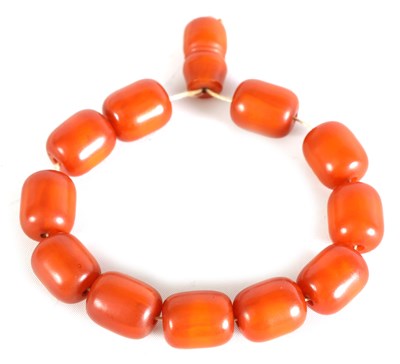 Lot 221 - A SET OF OVAL AMBER BEADS