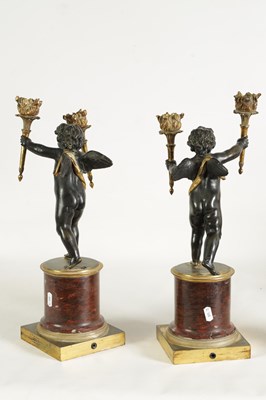 Lot 409 - A PAIR OF EARLY 19TH CENTURY FRENCH GILT BRONZE AND ROUGE MARBLE TWO BRANCH STANDING CHERUB CANDELABRA