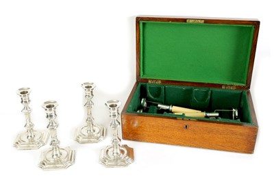 Lot 265 - A GEORGE V OAK CASED SET OF FOUR GEORGE I STYLE SILVER CANDLESTICKS