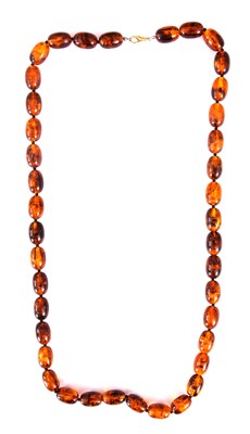Lot 359 - AN AMBER BEAD NECKLACE on string, of oval form...