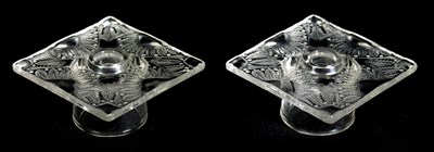 Lot 14 - LALIQUE, FRANCE. A PAIR OF CLEAR GLASS SQUARE CANDLE HOLDERS IN THE CHANTILLY DESIGN