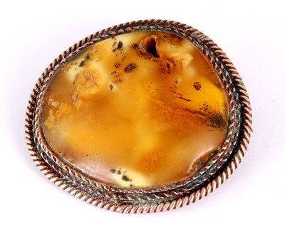 Lot 365 - A MOUNTED AMBER BROOCH with rope twist...