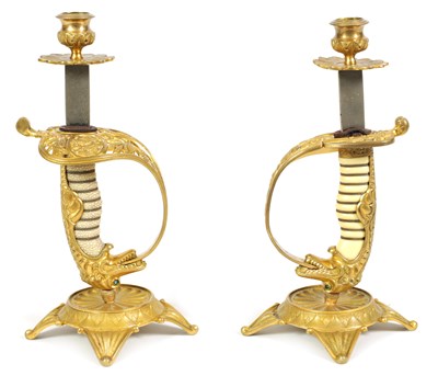 Lot 587 - A PAIR OF 19TH CENTURY GILT BRASS OFFICER’S SWORD CANDLESTICKS