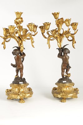 Lot A PAIR OF 19TH CENTURY BRONZE AND ORMOLU SEVEN BRANCH CANDELABRA