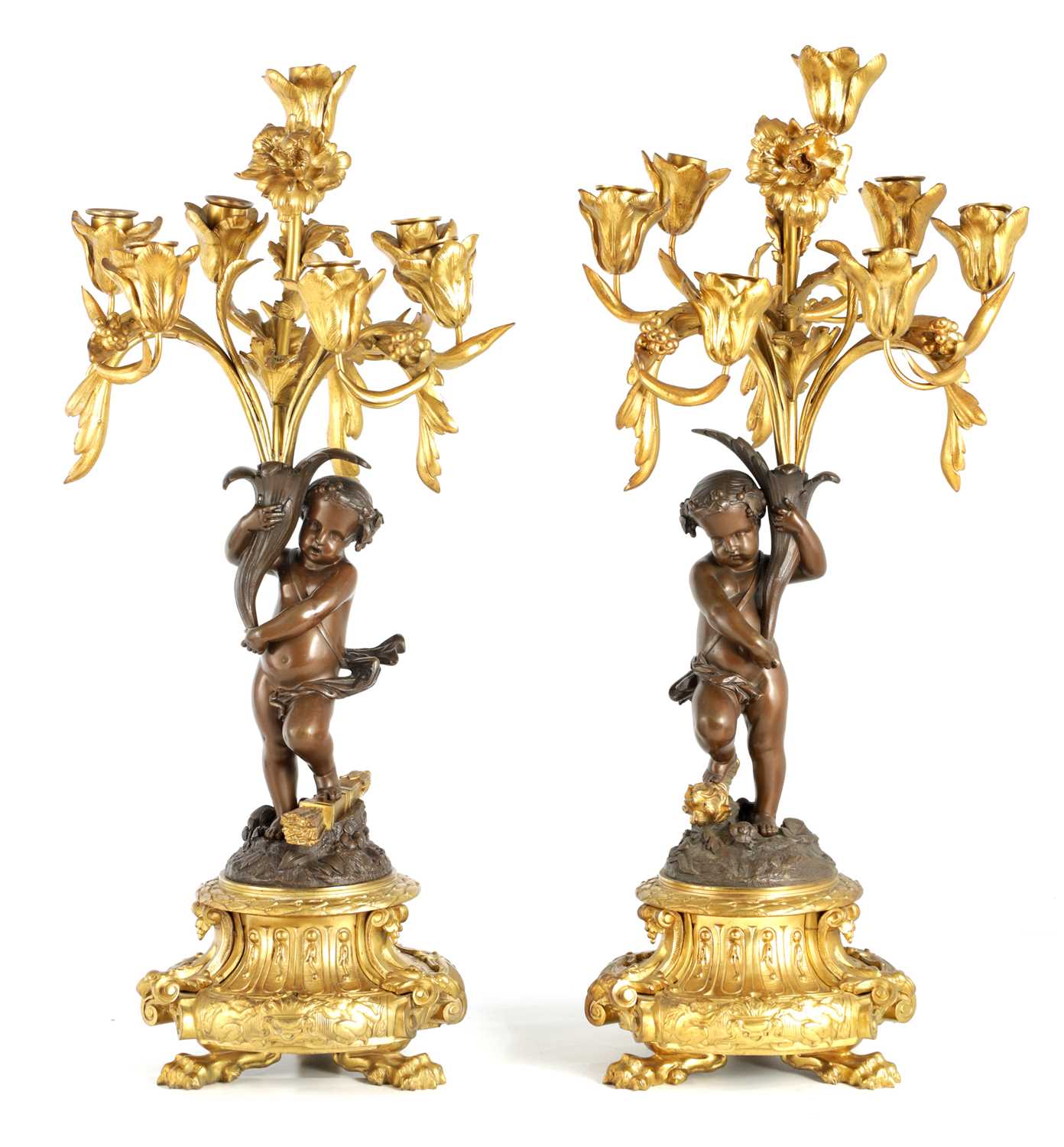 Lot A PAIR OF 19TH CENTURY BRONZE AND ORMOLU SEVEN BRANCH CANDELABRA