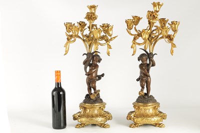 Lot A PAIR OF 19TH CENTURY BRONZE AND ORMOLU SEVEN BRANCH CANDELABRA