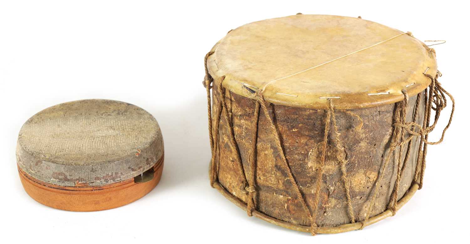 Lot 148 - A VINTAGE SNAKE SKIN TAMBOURINE TOGETHER WITH A BARK DRUM