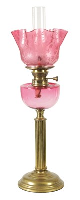 Lot 947 - A 19TH CENTURY LARGE BRASS CRANBERRY GLASS  OIL LAMP