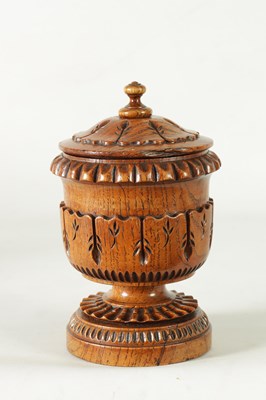 Lot 784 - AN UNUSUAL LATE REGENCY OAK URN SHAPED TEA CADDY