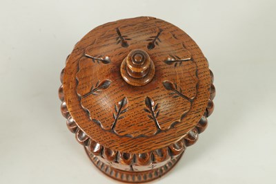 Lot 784 - AN UNUSUAL LATE REGENCY OAK URN SHAPED TEA CADDY
