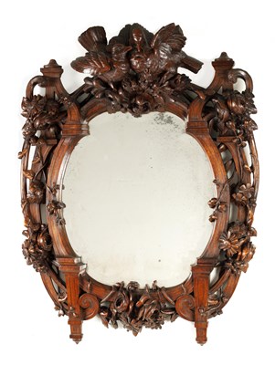 Lot 752 - A 19TH CENTURY WALNUT BLACK FOREST CARVED HANGING MIRROR