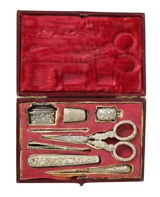 Lot 394 - A 19TH-CENTURY CASED EMBOSSED SILVER SEWING COMPENDIUM