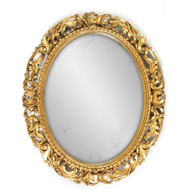 Lot 1355 - A LARGE OVAL 19TH CENTURY FLORENTINE CARVED GILT WOOD FRAMED MIRROR