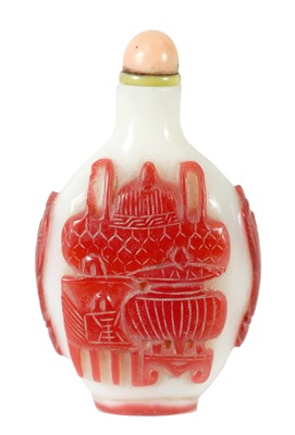 Lot 255 - A 19TH CENTURY CHINESE MILK GLASS AND CARVED RED CAMEO FLATTENED OVOID SNUFF BOTTLE