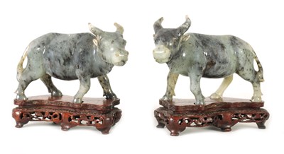 Lot 276 - A PAIR OF CHINESE-CARVED GREY JADE MODELS OF WATER BUFFALO