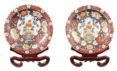 Lot 209 - A LARGE PAIR OF 20TH CENTURY JAPANESE IMARI CHARGERS WITH STAINED WOOD STANDS