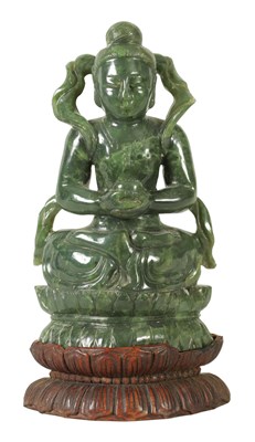 Lot 267 - A CHINESE CARVED SAGE GREEN JADE FIGURE OF A BUDDHA DEITY