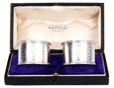 Lot 150 - A PAIR OF CASED SILVER NAPKIN RINGS with...