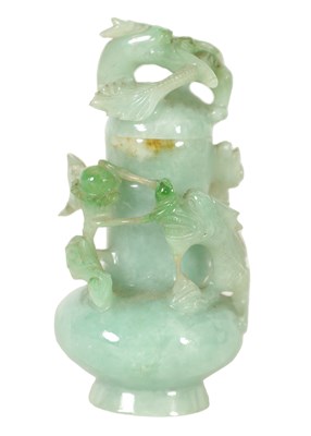 Lot 372 - A CHINESE CARVED PALE GREEN JADE LIDDED VASE