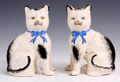 Lot 180 - A PAIR OF STAFFORDSHIRE POTTERY SEATED CATS 20....