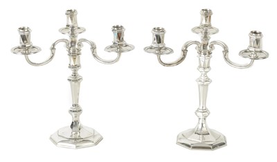 Lot 497 - A PAIR OF MID-20TH CENTURY CAST SILVER THREE-BRANCH CANDELABRA