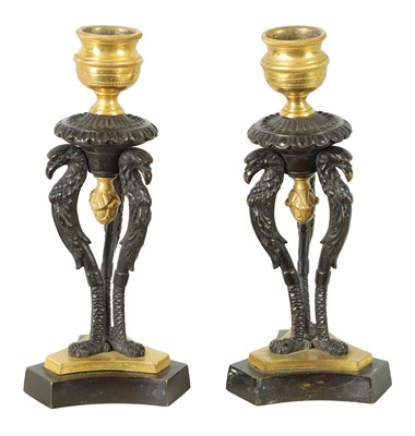 Lot 562 - A PAIR OF FRENCH EMPIRE BRONZE AND ORMOLU CANDLESTICKS