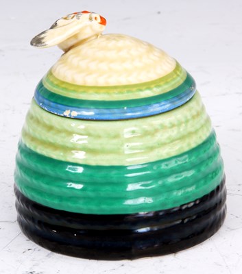 Lot 184 - A CLARICE CLIFF HONEY POT shaped as a bee hive...