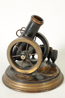 Lot 935 - A 19TH CENTURY EBONISED AND BRASS MOUNTED NOVELTY CIGAR AND MATCH HOLDER FORMED AS A CANNON