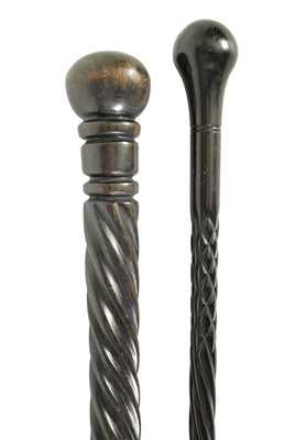 Lot 680 - TWO 20TH CENTURY EBONY AND EBONISED WALKING CANES