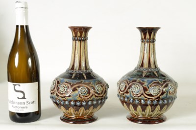 Lot 82 - A GOOD PAIR OF DOULTON LAMBETH FOOTED BULBOUS FLARED NECK VASES BEARING MONOGRAM FOR GEORGE TINWORTH