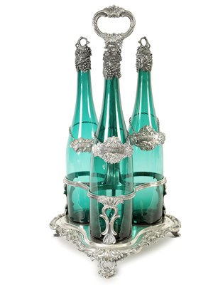 Lot 553 - A LATE GEORGIAN SILVER PLATE AND BRISTOL GREEN GLASS THREE BOTTLE SPIRIT TANTALUS