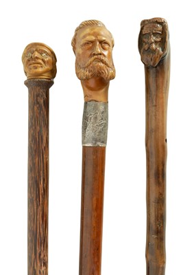 Lot 645 - THREE LATE 19TH CENTURY MASK HEADED WALKING STICKS