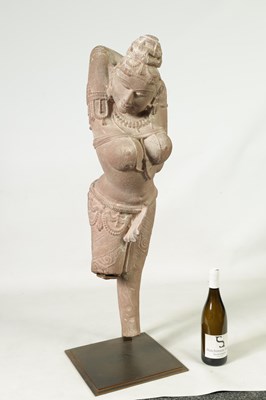 Lot 182 - A 12TH CENTURY CARVED RED SANDSTONE NORTHERN INDIAN APSARA FIGURE