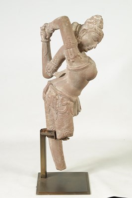 Lot 182 - A 12TH CENTURY CARVED RED SANDSTONE NORTHERN INDIAN APSARA FIGURE