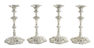 Lot 247 - A FINE SET OF FOUR GEORGE III LARGE CAST SILVER TABLE CANDLE STICKS IN THE ROCOCO MANNER