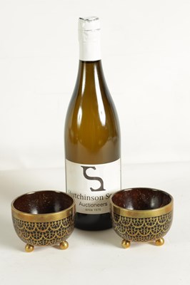 Lot 589 - A PAIR OF BRASS INLAID COCONUT SHELL BOWLS