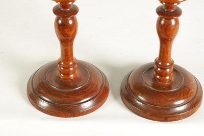 Lot 922 - A PAIR OF 19TH CENTURY TURNED WALNUT CANDLESTICKS