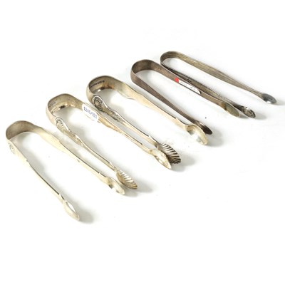 Lot 337 - A COLLECTION OF FIVE PAIRS OF GEORGIAN AND VICTORIAN SILVER SUGAR TONGS