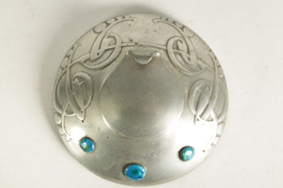 Lot 555 - AN ARTS AND CRAFTS TUDRIC PEWTER CIRCULAR INK WELL AND LINER AFTER DESIGNS BY ARCHI BALD KNOX