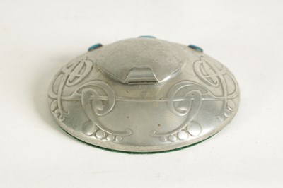 Lot 555 - AN ARTS AND CRAFTS TUDRIC PEWTER CIRCULAR INK WELL AND LINER AFTER DESIGNS BY ARCHI BALD KNOX