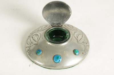 Lot 555 - AN ARTS AND CRAFTS TUDRIC PEWTER CIRCULAR INK WELL AND LINER AFTER DESIGNS BY ARCHI BALD KNOX